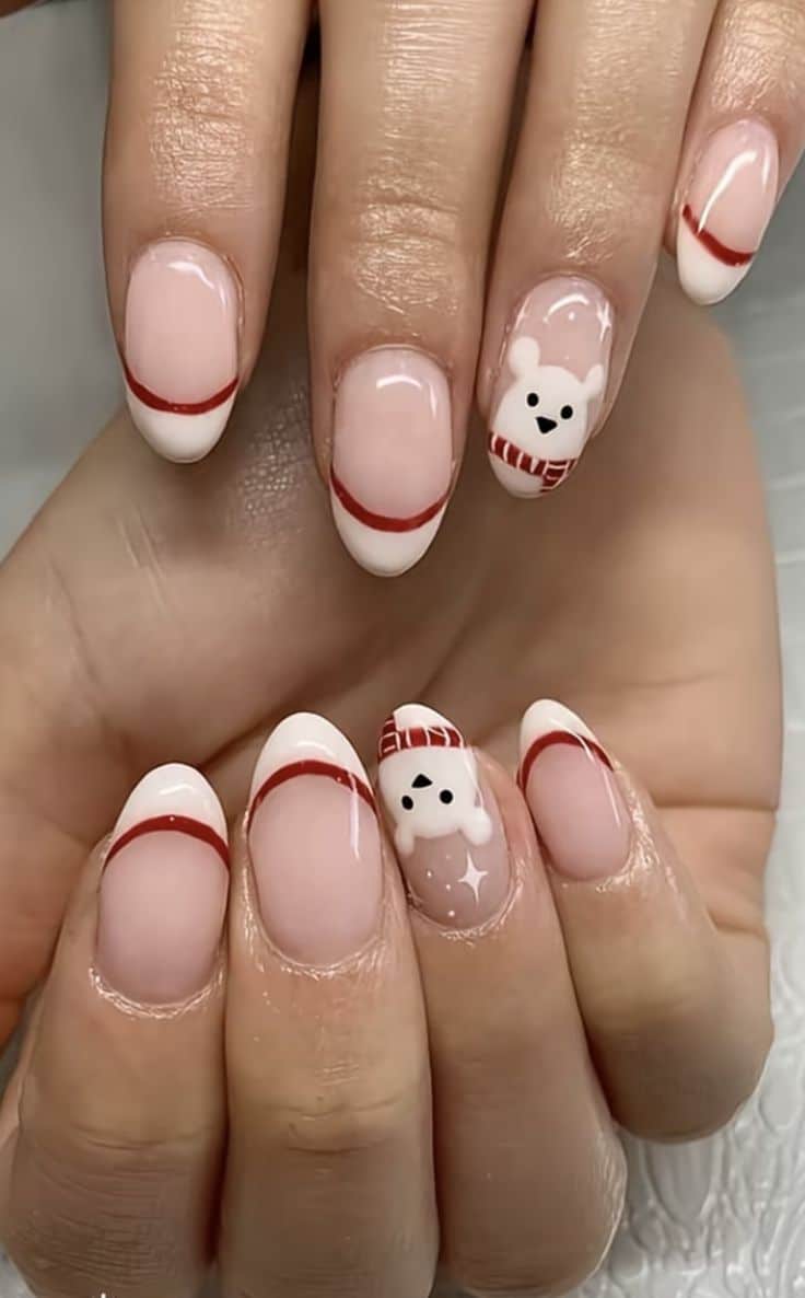 White French tip Christmas nails with red lines and a polar bear accent