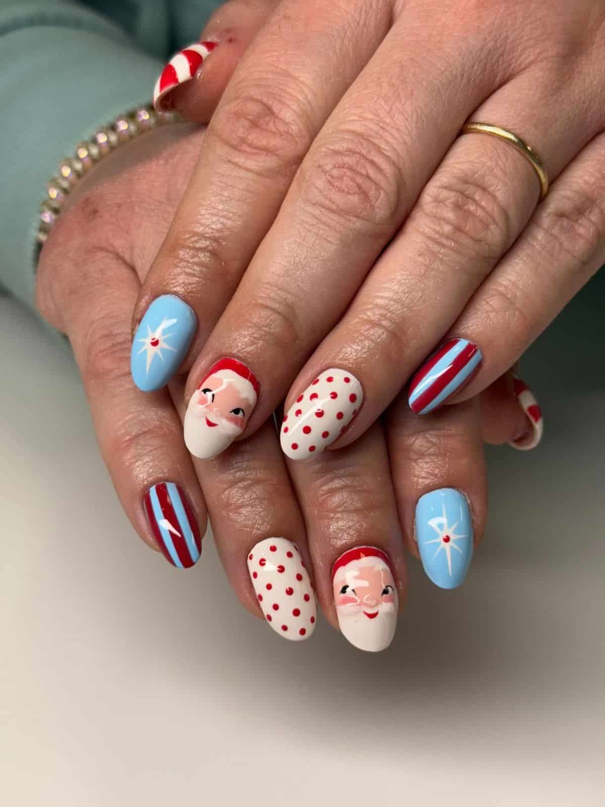 Retro Christmas nails with vintage Santa faces, baby blue starbursts, red polka dots and stripes