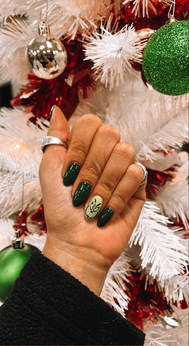 Forest green Christmas nails with a Grinch accent nail