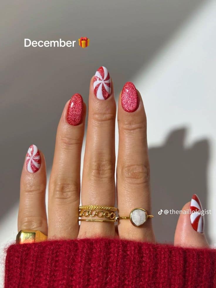 Red sparkle Christmas nails with peppermint swirl accents