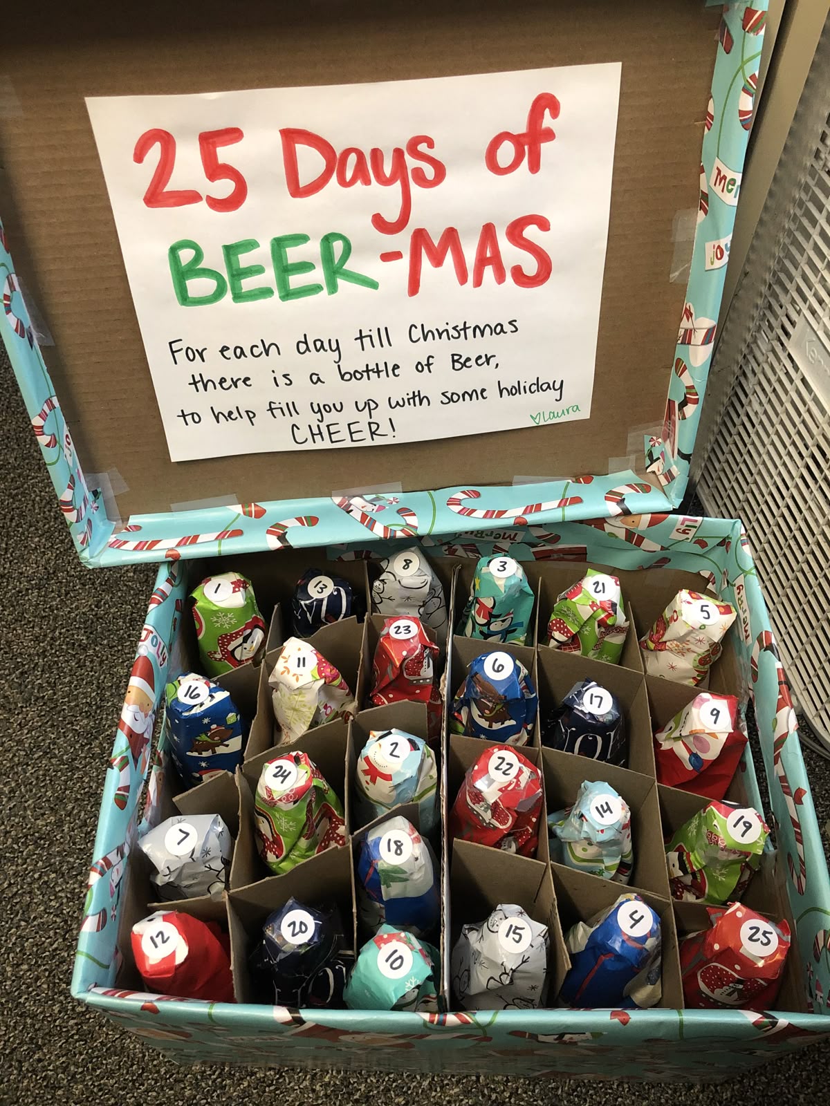 Beer advent calendar box with 25 wrapped bottles in a cardboard divider and a handwritten lid sign