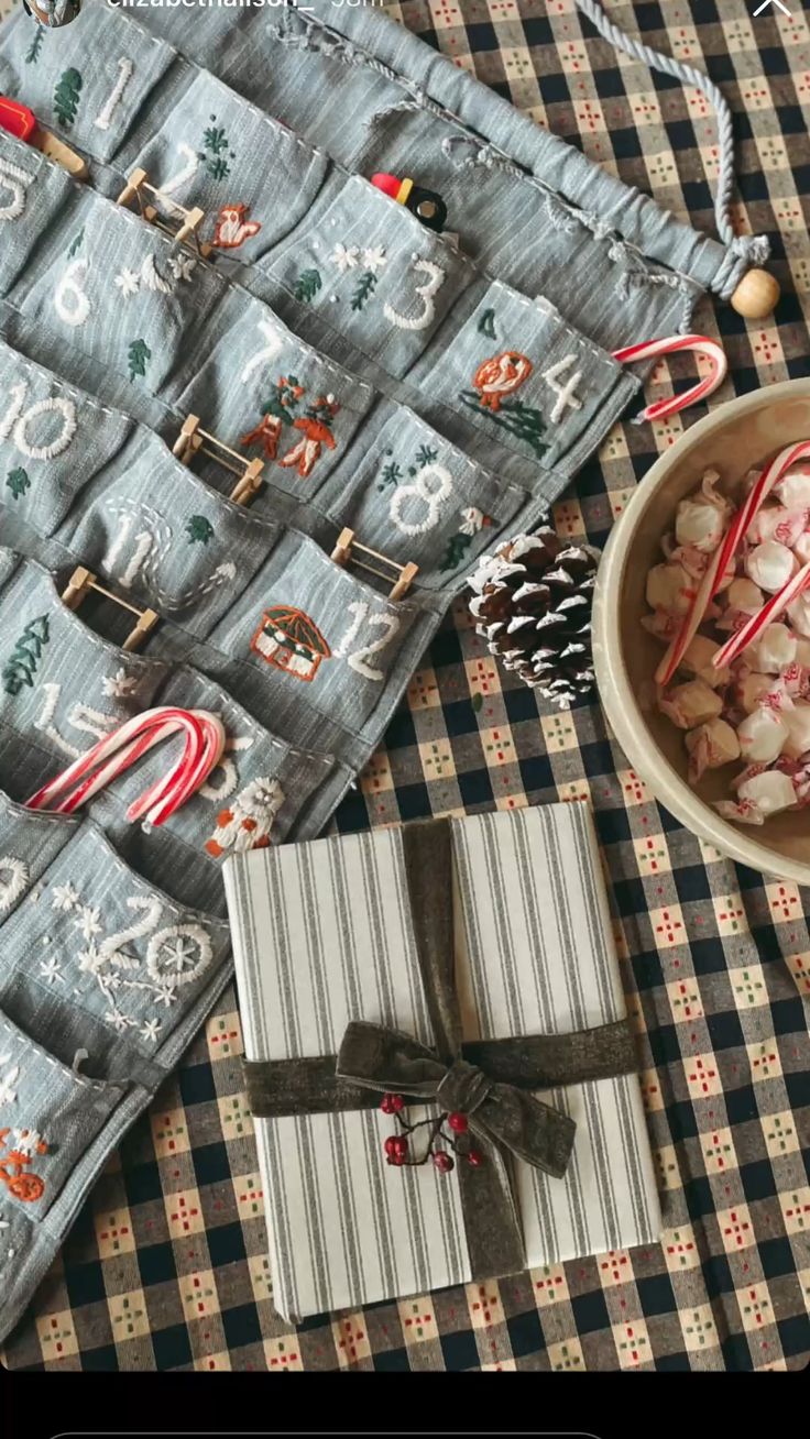 Blue linen advent calendar with embroidered white numbers and tiny Christmas motifs