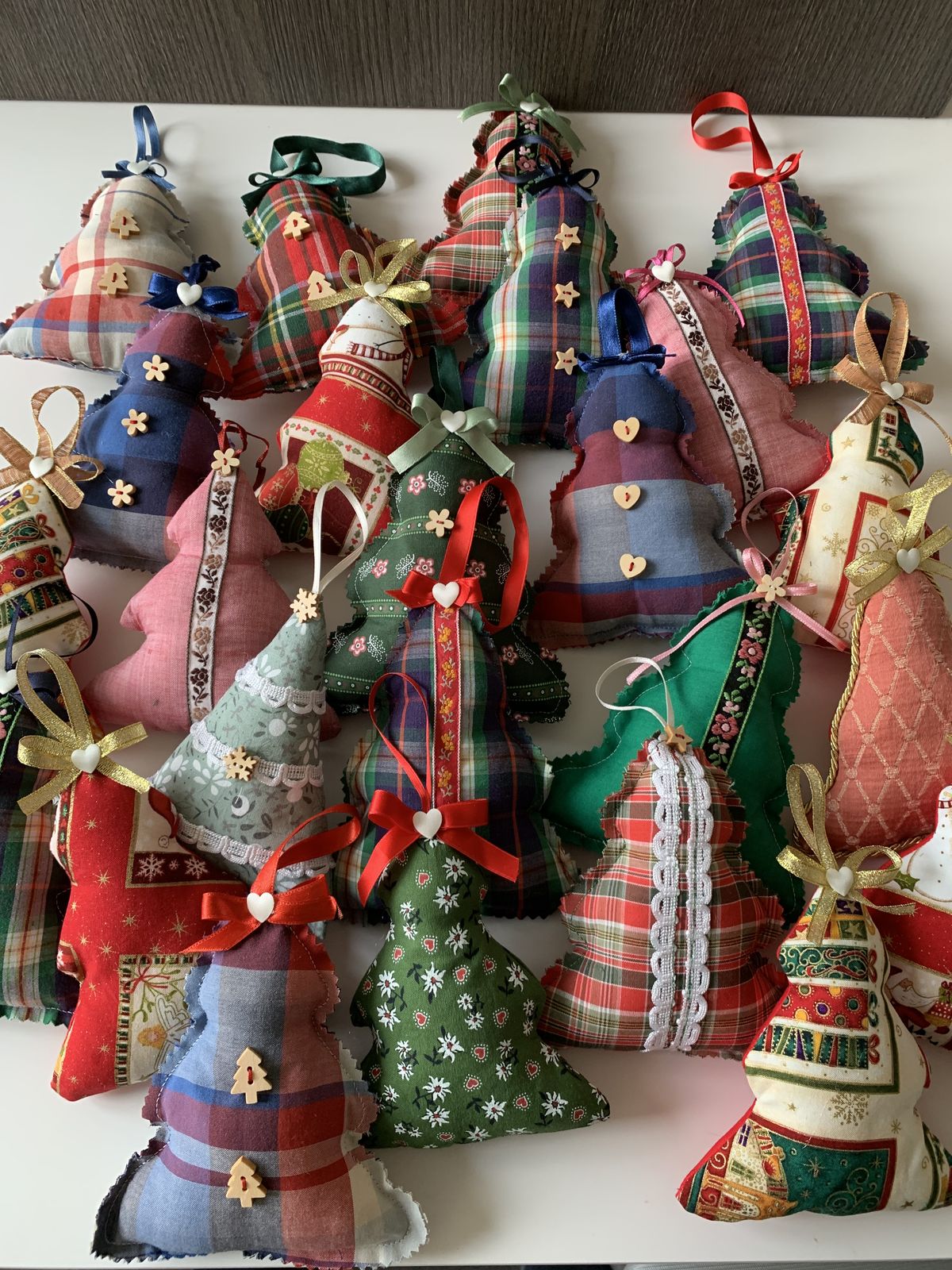 Stuffed fabric Christmas tree ornaments in tartan and festive prints with trim, wooden buttons and ribbon loops