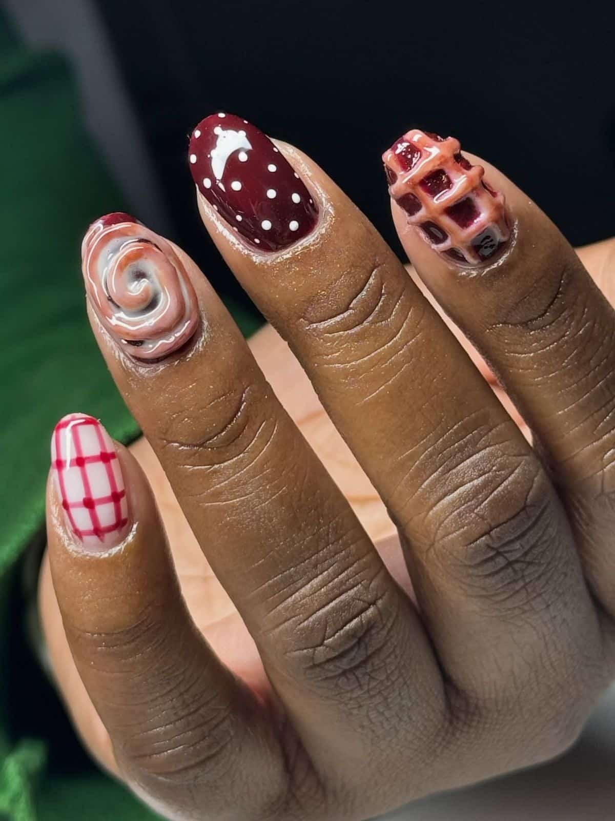 Almond nails with 3D cinnamon scroll, lattice pie texture, burgundy polka dots and red gingham