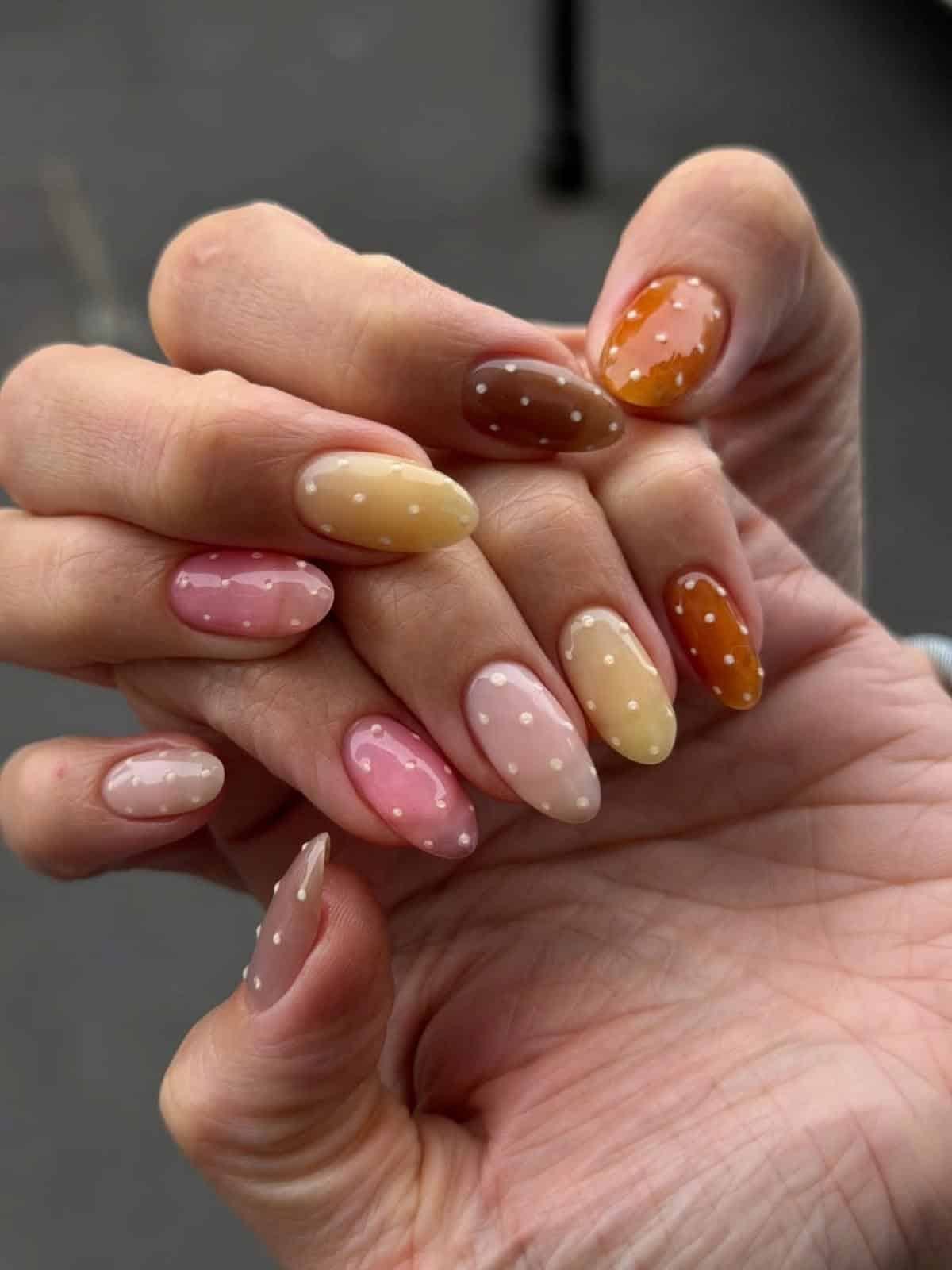 Almond jelly nails in pink, butter yellow, nude and caramel with tiny raised cream dots