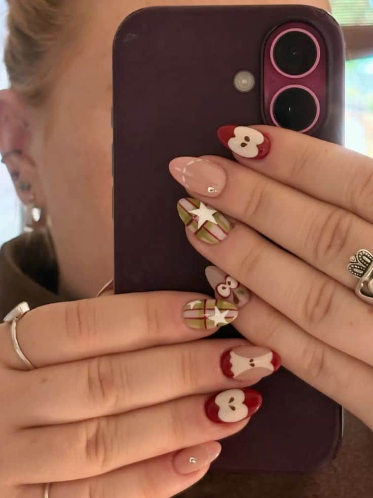 Almond nails with red apple slice designs, olive and red plaid with white stars and a sheer nude accent