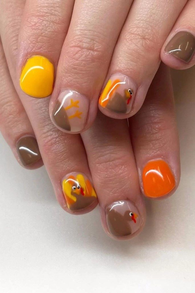 Short nails in mustard, burnt orange and mocha with painted turkey designs