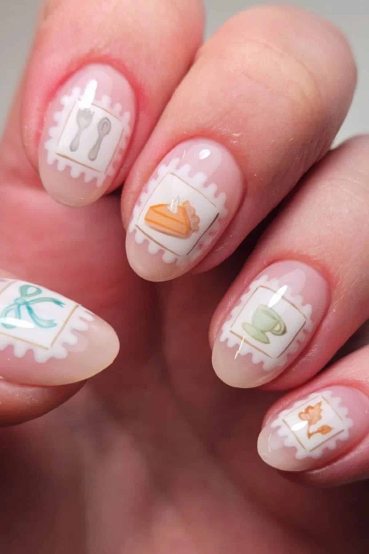 Almond nails with postage stamp frames featuring pumpkin pie, cutlery, a teacup, a bow and an autumn leaf